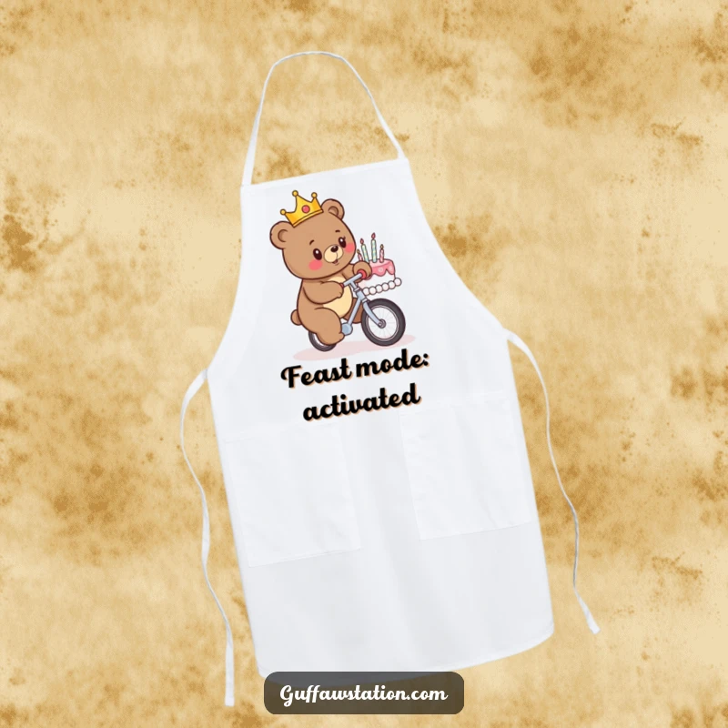 Funny chef apron featuring a crowned bear riding a unicycle towards a birthday cake, bringing humorous chaos to the kitchen during cooking.