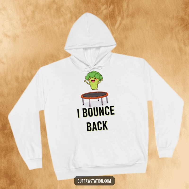 Funny hoodie featuring a giggling broccoli launching itself from a trampoline into the air, perfect for active and cheerful vibes.