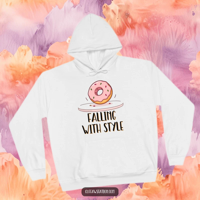 Funny donut falling off a table in slow motion printed on a soft hoodie, offering warmth and humor.