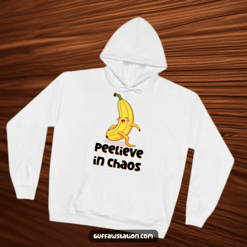 Funny hoodie with a giggling banana in mid-slip on a banana peel, exhibiting exaggerated posture and a startled look for maximum humor.