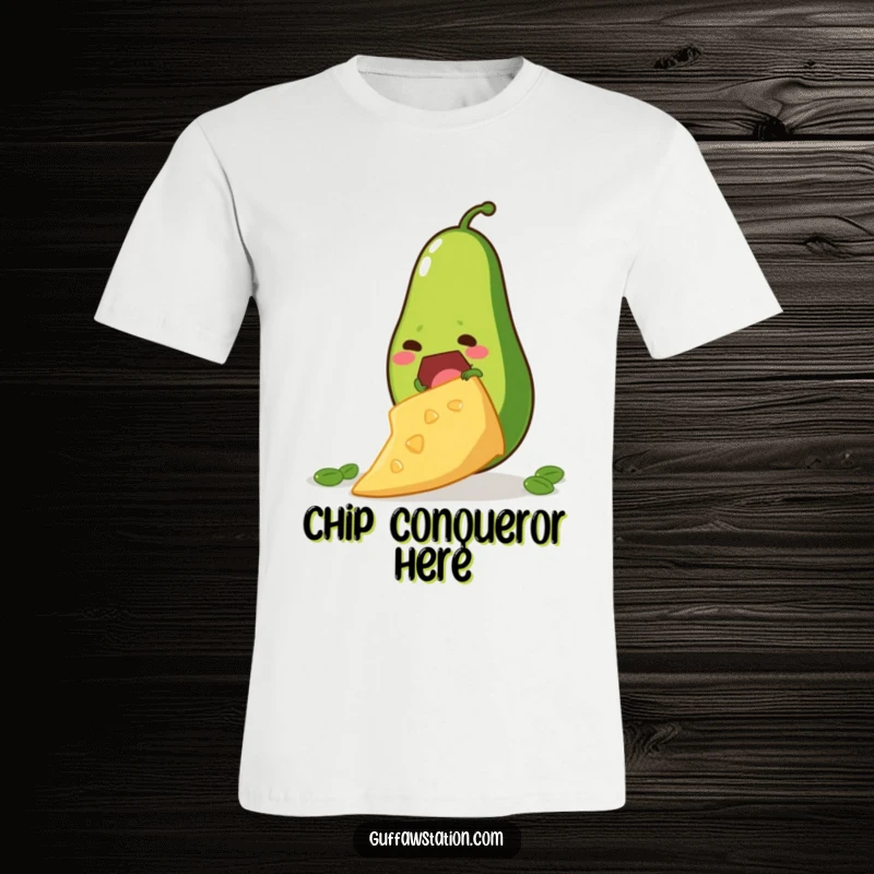 Funny t-shirt depicting a determined avocado attempting to climb a giant tortilla chip, symbolizing aspiration and foodie fun.