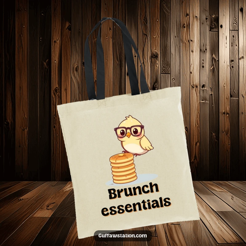 A bird wearing glasses carefully balancing a stack of pancakes on a tote bag, showcasing breakfast-themed humor.