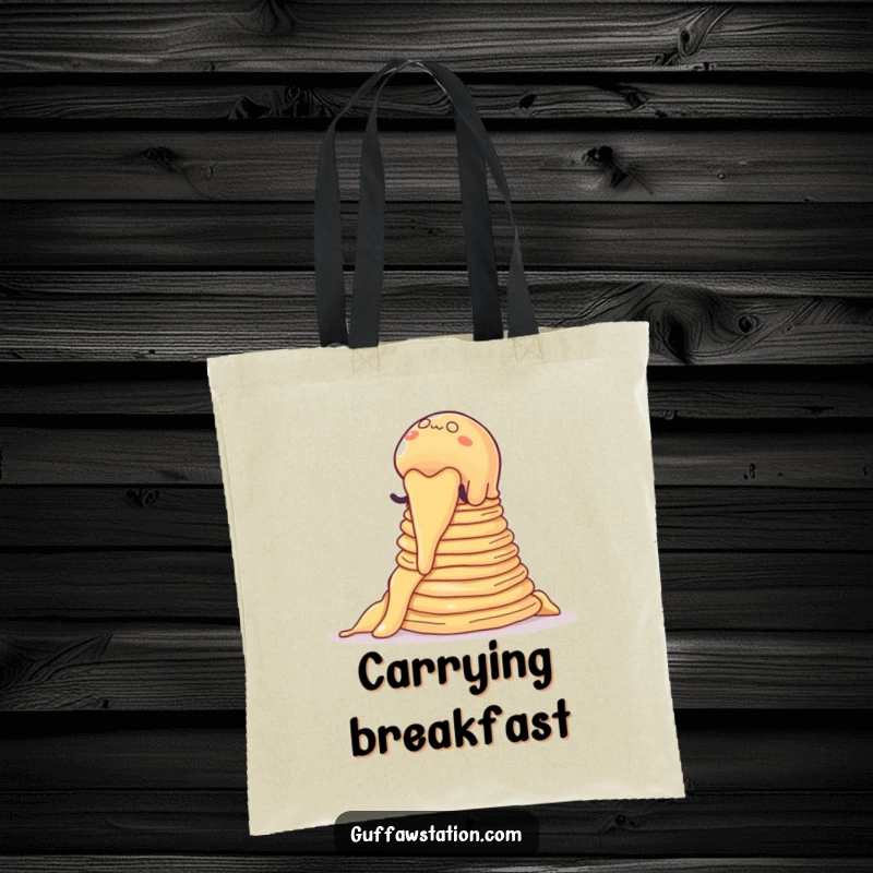 Funny tote bag showing a wobbly jelly blob climbing a stack of pancakes, a cartoon depiction of a breakfast challenge.