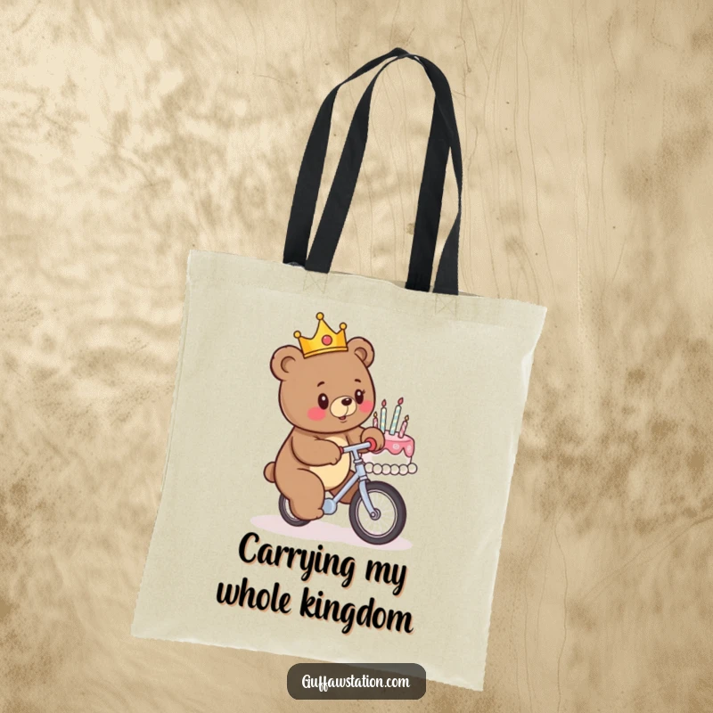 Funny tote bag featuring a crowned bear attempting to ride a unicycle into a birthday cake, a comical scene for everyday use.